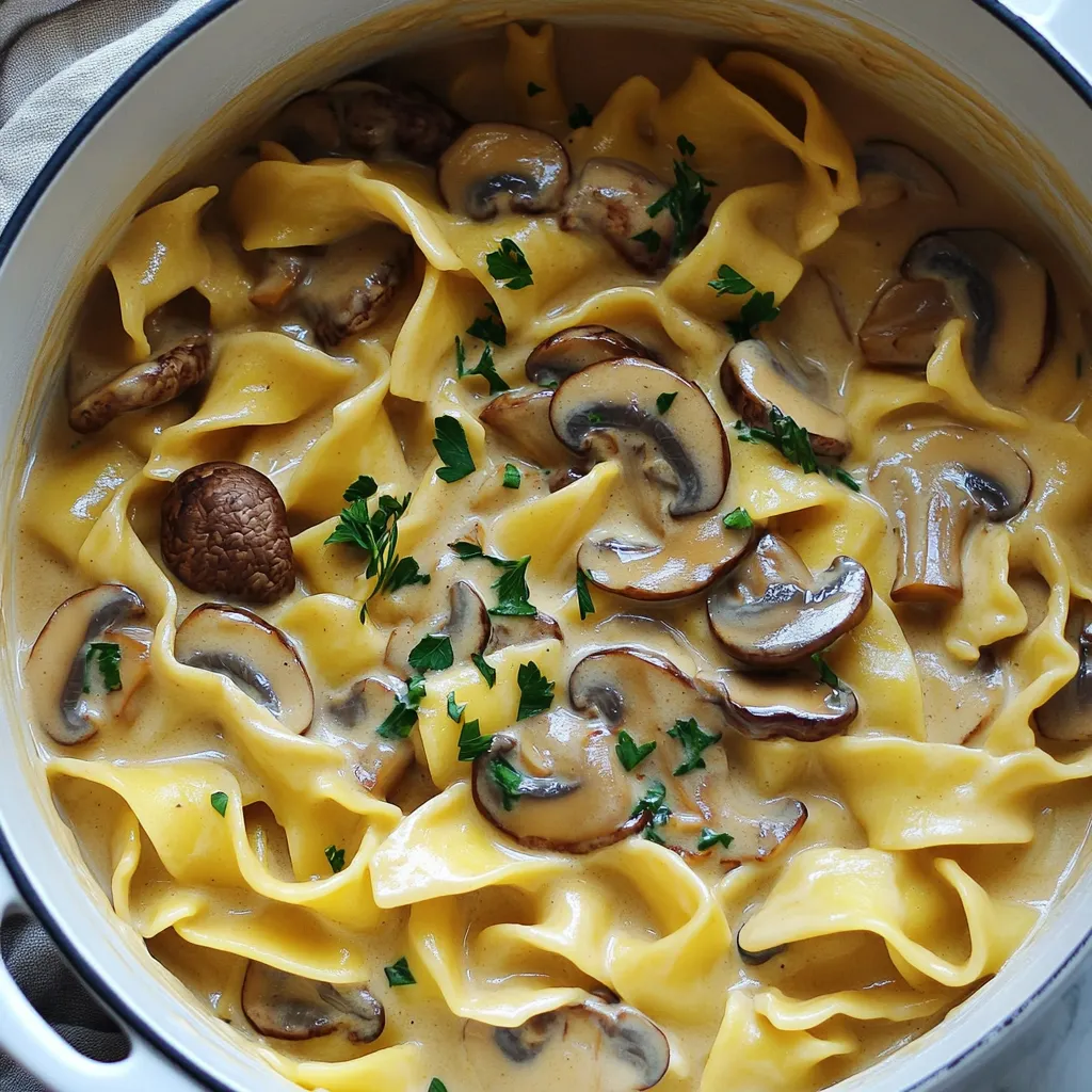 Here’s what you need for the One Pot Creamy Mushroom Stroganoff: - 12 oz wide egg noodles - 2 tablespoons olive oil - 1 medium onion, finely diced - 3 cloves garlic, minced - 16 oz mixed mushrooms (cremini, shiitake, and button), cleaned and sliced - 1 teaspoon dried thyme - 1 teaspoon smoked paprika - 4 cups vegetable broth - 1 cup heavy cream or coconut milk (for vegan alternative) - 2 tablespoons soy sauce - Salt and freshly ground black pepper to taste - Fresh parsley, chopped (for garnish) Each ingredient builds the flavor and texture of this dish. The egg noodles are the base, soaking up the creamy sauce. The mushrooms give a rich, earthy taste. Olive oil helps to sauté the onion and garlic, which add sweetness. Thyme and smoked paprika give depth to the flavor. Vegetable broth is the heart of the sauce, while the cream or coconut milk creates a velvety finish. Finally, soy sauce adds umami, and fresh parsley brightens the dish. Gathering these ingredients will set you up for a delicious meal. Enjoy every bite! 1. First, heat 2 tablespoons of olive oil in a large pot on medium heat. 2. Add 1 medium onion, finely diced. Sauté for 3-4 minutes until it turns translucent. 3. Mix in 3 cloves of minced garlic and stir. 4. Add 16 ounces of mixed mushrooms. Cook for 5-6 minutes until soft, stirring often. 5. Sprinkle in 1 teaspoon of dried thyme and 1 teaspoon of smoked paprika. Stir for 1 minute to blend the spices. 1. Now, add 12 ounces of wide egg noodles to the pot. 2. Pour in 4 cups of vegetable broth and 2 tablespoons of soy sauce. 3. Turn up the heat and bring everything to a gentle boil. 4. Once boiling, reduce the heat and cover the pot. Let it simmer for 10-12 minutes. Stir occasionally to keep noodles from sticking. 1. After the noodles are al dente, stir in 1 cup of heavy cream or coconut milk. 2. Mix well to create a rich sauce. Allow it to simmer for another 5 minutes. 3. Taste your stroganoff. Season with salt and freshly ground black pepper according to your liking. Serve it hot, and enjoy the creamy goodness! - Preventing noodles from sticking To stop noodles from sticking, stir them well during cooking. Add a splash of olive oil to the water. This keeps them separate and nice. - Achieving the perfect creaminess For the best creaminess, add the cream slowly. Stir it in gently. This helps the sauce blend well with the noodles. - Garnishing with parsley Always garnish with fresh parsley. This adds color and freshness. It makes your dish look and taste even better. - Pairing with sides or wine Serve your stroganoff with a simple salad or crusty bread. A light white wine pairs nicely too, enhancing the meal. - Using fresh herbs Fresh herbs can boost the flavor. Try adding thyme or basil. They add a lovely aroma and taste. - Optional spice adjustments If you like a kick, add red pepper flakes. For a smoky touch, more smoked paprika works great. Adjust to your taste! {{image_4}} You can easily modify this recipe for different diets. For a vegan option, swap heavy cream with coconut milk. This keeps the dish creamy and rich without dairy. You can also use vegetable broth instead of chicken broth for a fully plant-based dish. For gluten-free substitutions, choose gluten-free wide noodles. These noodles cook well and absorb flavor, just like regular egg noodles. Always check labels to ensure the other ingredients are gluten-free too. Adding proteins can change the dish's feel. You can toss in cubed tofu for a vegan boost. If you prefer meat, chicken works well too. Cook it first before adding the vegetables for best results. Using different mushroom types can bring new flavors. Try portobello mushrooms for a meatier taste. Or, mix in some oyster mushrooms for a delicate touch. Each type offers a unique twist to your stroganoff. You can adjust the sauce thickness to your liking. For a thicker sauce, add more cream or let it simmer longer. If you prefer a thinner sauce, add a bit more broth. This keeps the dish light and easy to enjoy. Incorporating more vegetables can also change the texture and flavor. Consider adding spinach or peas near the end of cooking. This not only boosts nutrition but also adds color to your meal. To keep your One Pot Creamy Mushroom Stroganoff fresh, use airtight containers. Glass or plastic containers work well. Make sure to let the dish cool before sealing it. This helps prevent moisture buildup. Store the leftovers in the fridge for up to three days. When it’s time to eat those tasty leftovers, you have two good options. The stovetop is best for keeping the creamy texture. Just heat in a pan over low heat, stirring often. If you’re in a hurry, use the microwave. Heat in short bursts, stirring in between. This way, it warms evenly. If you want to freeze the stroganoff, let it cool first. Transfer it to freezer-safe containers. Make sure to leave some space at the top for expansion. You can freeze it for up to three months. To defrost, move it to the fridge overnight. Reheat on the stovetop for the best taste and texture. One Pot Creamy Mushroom Stroganoff lasts about 3 to 5 days in the fridge. Store it in an airtight container to keep it fresh. When you are ready to eat, just reheat it gently on the stove. Stir it often to keep it from sticking. Yes, you can use different types of noodles! Try egg noodles, penne, or even gluten-free pasta. Make sure to adjust the cooking time based on the noodles you choose. Just check the package for guidance. Absolutely! You can make this dish ahead of time. Prepare the stroganoff and let it cool. Store it in an airtight container in the fridge. When you are ready to serve, just reheat it on the stove, adding a splash of broth if needed. Yes, adding protein is easy. Cooked chicken, beef, or tofu works well. Just add it to the pot when you add the noodles. This makes the dish more filling and adds extra flavor. You can pair it with a simple side salad or garlic bread. These sides balance the meal and add freshness. For a drink, try a light white wine or sparkling water with lemon. Yes, fresh herbs can enhance the flavor! Use thyme, parsley, or even chives. Just chop them finely and add them at the end of cooking. This keeps their flavor bright and fresh. To add some heat, try adding crushed red pepper flakes or a dash of hot sauce. Start with a small amount, then taste and adjust. This way, you can control the heat to your liking. Yes, if you want a thicker sauce, you can make a slurry. Mix a tablespoon of cornstarch with cold water, then add it to the pot while stirring. Let it cook for a few minutes to thicken up nicely. Yes, you can freeze this dish. Let it cool completely, then transfer it to a freezer-safe container. It can last for up to 3 months. To reheat, thaw it overnight in the fridge and warm it on the stove. In this blog post, we explored how to make a creamy mushroom stroganoff using simple steps. We discussed ingredients, preparation, cooking tips, and storage methods. You now have the tools to create a tasty dish easily. Remember, you can adjust flavors and make it vegan or gluten-free as needed. This dish not only feeds the body but also warms the soul. Enjoy your time in the kitchen. Happy cooking!