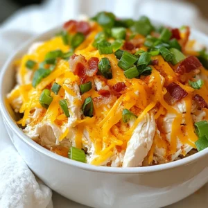 To make Keto Crack Chicken, gather the following ingredients: - 2 pounds boneless, skinless chicken thighs - 1 packet ranch dressing seasoning mix - 8 ounces cream cheese, softened to room temperature - 1 cup shredded sharp cheddar cheese - 1/2 cup green onions, finely chopped - 1/2 cup bacon bits (optional for added crunch) - 1 tablespoon garlic powder - 1 tablespoon onion powder - Salt and freshly ground black pepper, to taste These ingredients work together to create a rich and creamy dish. You can make Keto Crack Chicken your own by changing a few items: - Chicken: You can use chicken breasts instead of thighs if you prefer. - Cream Cheese: Swap it with Greek yogurt for a lighter option. - Cheese: Try using mozzarella or pepper jack for a different taste. - Bacon: Leave it out if you want a lighter dish or use turkey bacon. - Seasonings: Add spices like paprika or cayenne for extra heat. These changes can keep your meals fresh and exciting. To cook Keto Crack Chicken, you'll need some basic tools: - Slow cooker or Instant Pot - Measuring cups and spoons - Mixing spoon - Two forks for shredding the chicken - Cutting board and knife for chopping green onions Having these tools ready will make your cooking process smooth and easy. {{ingredient_image_2}} You can cook Keto Crack Chicken in two ways: a slow cooker or an Instant Pot. - Slow Cooker: Place the chicken thighs in the slow cooker. Add the ranch seasoning, garlic powder, onion powder, salt, and pepper. Spread the cream cheese on top. Cook on low for 6-7 hours or high for 3-4 hours. Your chicken will come out tender and juicy. - Instant Pot: This method is quicker. Put the chicken in the pot, add the seasonings, and cream cheese. Seal the lid and cook on high for 15 minutes. Let the pressure release naturally. This step makes the chicken even more tender. Start by preparing your chicken. Place the chicken thighs into the cooker and sprinkle the ranch mix evenly. This adds tons of flavor. Then, sprinkle the garlic and onion powders, along with salt and pepper. Next, dollop the cream cheese on top. This will melt and mix in, creating a rich sauce. For the cooking time, use your chosen method. Check the chicken after cooking. It should be fork-tender. Once your chicken is cooked, take two forks to shred it inside the pot. This step is fun! Mix it well to blend the cream cheese with the chicken. Now, it’s time for the cheese! Add the shredded sharp cheddar and optional bacon bits. Stir until the cheese melts and everything combines. This adds creaminess and flavor. Finally, fold in most of the chopped green onions. Save some for garnish. This adds a fresh touch to your dish. Serve your Keto Crack Chicken warm with a sprinkle of green onions and cheese. Enjoy the tasty and easy meal! To shred chicken well, start with cooked chicken thighs. Use two forks to pull the meat apart. Hold one fork steady. Use the other fork to tear the meat. This method gives nice, even pieces. If the chicken is still warm, it shreds easier. For creamy results, always use softened cream cheese. Take it out of the fridge early. Let it sit at room temperature for about 30 minutes. When you add it to the chicken, it spreads better. Stir well after shredding. This helps combine all flavors nicely. Garnish your Keto Crack Chicken for a nice touch. Use chopped green onions for freshness. Add a sprinkle of extra cheddar cheese on top. This adds color and flavor. Serve it warm in bowls. Pair it with steamed broccoli or cauliflower for a full meal. Enjoy the taste and your beautiful plate! Pro Tips Use Fresh Ingredients: Fresh herbs and high-quality cheeses can elevate the flavor of your Keto Crack Chicken, making it even more delicious. Adjust Seasoning: Taste the mixture before serving and adjust seasoning if necessary. A little extra salt or pepper can make a big difference! Store Leftovers Properly: If you have leftovers, store them in an airtight container in the fridge for up to 4 days, or freeze for longer storage. Pair with Low-Carb Sides: This dish pairs wonderfully with low-carb vegetables like zucchini noodles or a fresh salad to keep your meal balanced and keto-friendly. {{image_4}} You can make Keto Crack Chicken even better with simple swaps. Try using turkey instead of chicken. Ground turkey works well and is leaner. If you want to cut carbs, replace the ranch seasoning with homemade herbs. Use thyme, parsley, and dill for a fresh twist. You can also swap cream cheese for Greek yogurt. This keeps the dish creamy but adds a nice tang. Adding veggies boosts flavor and nutrition. You can toss in bell peppers, spinach, or zucchini. Chop them finely and mix them with the chicken at the start. They will soften as the chicken cooks. You can also add broccoli for a crunchy texture. It’s a great way to sneak in healthy greens, making the dish even better. Cheese can change the taste of this dish. While sharp cheddar is great, try pepper jack for heat. It adds a nice kick and melts perfectly. Mozzarella is another option. It gives a creamy, stretchy texture. You can also mix different cheeses for a unique flavor. Experimentation with cheese can make this dish exciting every time you cook it! After enjoying your Keto Crack Chicken, store leftovers in an airtight container. This keeps the chicken fresh and tasty. Let the dish cool down before sealing it. Place it in the fridge for up to four days. If you want to keep it longer, freezing is a great option. When you're ready to eat your leftovers, you have a few easy options. You can reheat in the microwave. Just place a portion on a microwave-safe plate and cover it. Heat for one to two minutes, stirring halfway through. You can also reheat on the stove. Just add a bit of water or broth in a pan. Heat over medium until warm, stirring often. If you want to freeze Keto Crack Chicken, first let it cool completely. Then, scoop it into freezer-safe bags or containers. Make sure to remove as much air as possible. Label the bags with the date. You can freeze it for up to three months. To enjoy it later, thaw overnight in the fridge. Then, reheat as described above. This makes meal prep a breeze! Yes, Keto Crack Chicken is perfect for meal prep. You can make it ahead of time. Store it in the fridge for up to four days. This dish also freezes well. Just place it in an airtight container. When you are ready to eat, simply reheat it. You can make Keto Crack Chicken without cream cheese. Try using sour cream or Greek yogurt instead. Both options will add creaminess and flavor. The dish will still taste great, but it may not be as rich. Adjust seasonings if needed to balance the flavors. Keto Crack Chicken pairs well with many sides. Here are some tasty options: - Steamed broccoli - Cauliflower rice - Zucchini noodles - Green salad - Roasted Brussels sprouts These sides are low in carbs and add nutrition to your meal. Enjoy your dinner! This article covered everything you need to know about making Keto Crack Chicken. We explored the full ingredient list, cooking methods, and helpful tips. You learned about ingredient swaps for keto diets, adding extra veggies for taste, and the best ways to store leftovers. Remember, small changes can make a big difference in flavor. Enjoy your cooking and putting your own spin on this dish! Keep experimenting to make it truly yours.